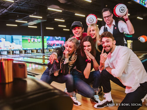 Group of young adults taking a selfie at a bowling attraction in Branson.