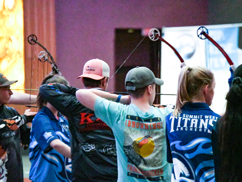 Group of students shooting archery in a state tournament.