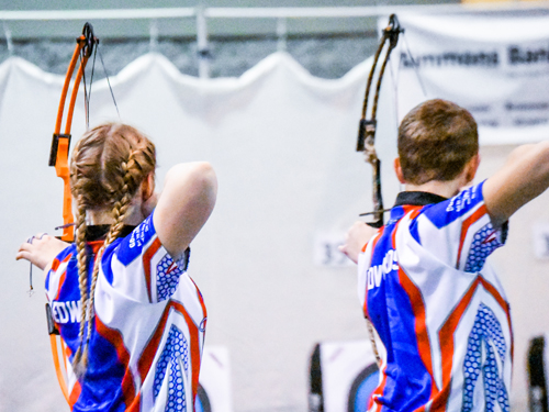 Two contenders shooting in a State Archery Tournament.