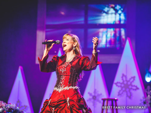Woman singing at the Brett Family Christmas show.