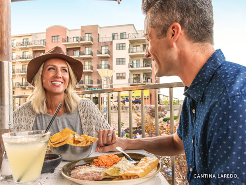 husband and wife eating mexican cuisine at an outdoor dining area in Branson.