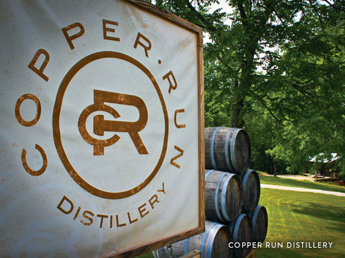 Wine barrels and sign from Copper Run Distillery in Branson.