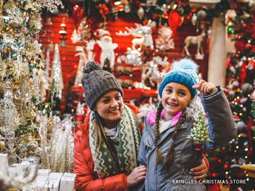 Mother and daughter holding a Christmas ornament in the largest Christmas store in Missouri found in Branson.