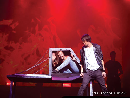 Magician doing a disappearing trick with a woman assistant on a live show stage in Branson.