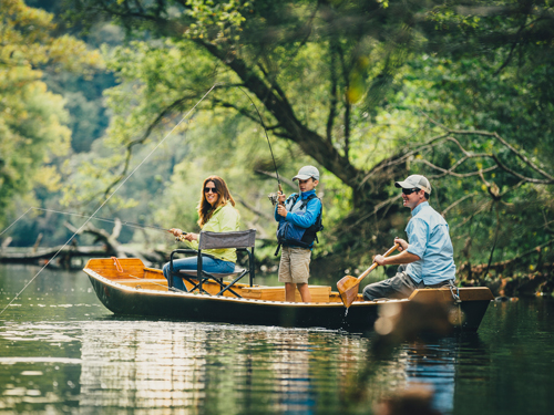 Family of three fishing in a cove on a lake in Branson.