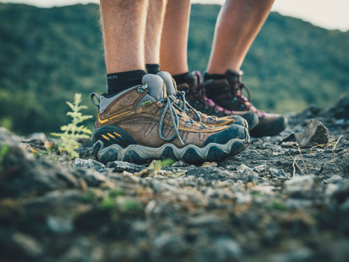 Close look of man and woman's hiking boots during a scenic hike in Branson.