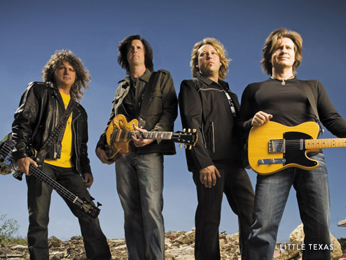 Four country stars posing with their instruments.