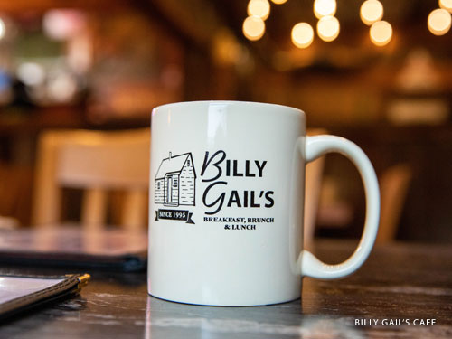 White coffee cup with local Branson cafe's logo on the side.