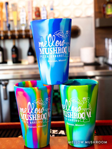 Three Mellow Mushroom alcohol cups stacked on the Dude's Daiquiri Bar.