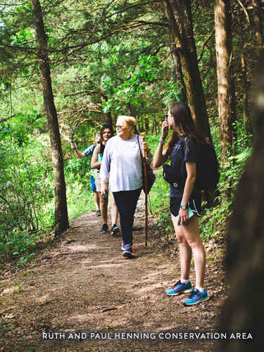 Group of friends hiking through a scenic trail in Branson.