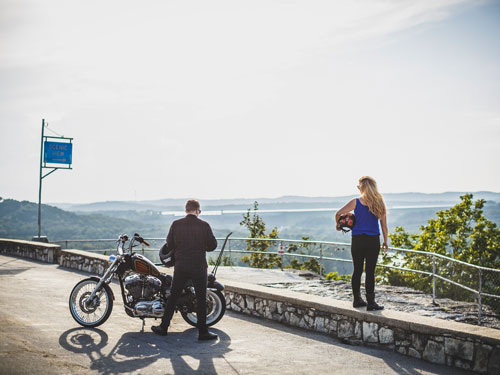 Man and woman stopped at a scenic overlook with their motorcycle in Branson.