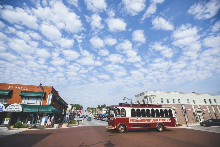 Branson Trolley in front of shops in Downtown Branson.