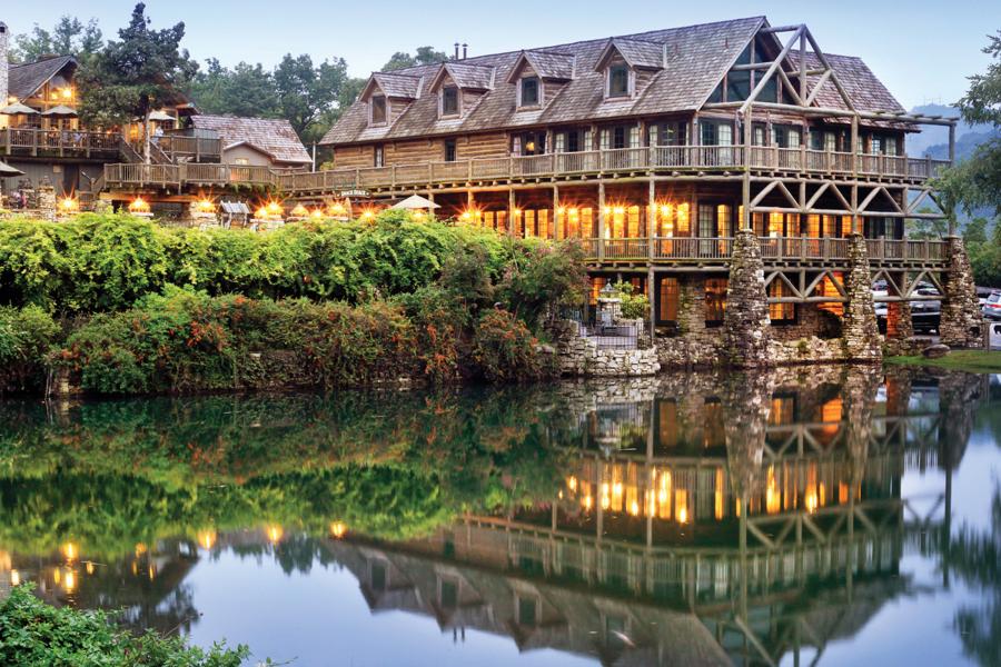 A lodge and its reflection in the lake.