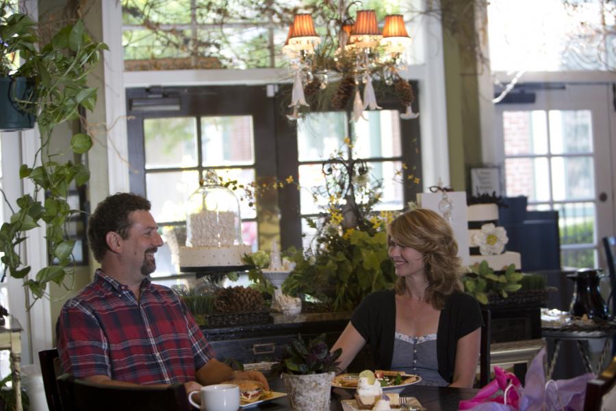 Couple eating lunch inside of a cafe.