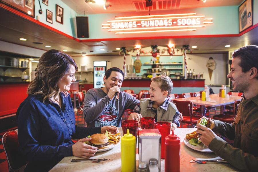 Waiter singing to a family of three at Mel's Diner in Branson, MO.