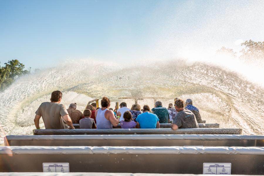 group riding boat with water splashing up