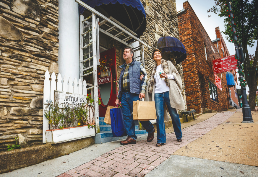 couple holding hands shopping in downtown branson during fall