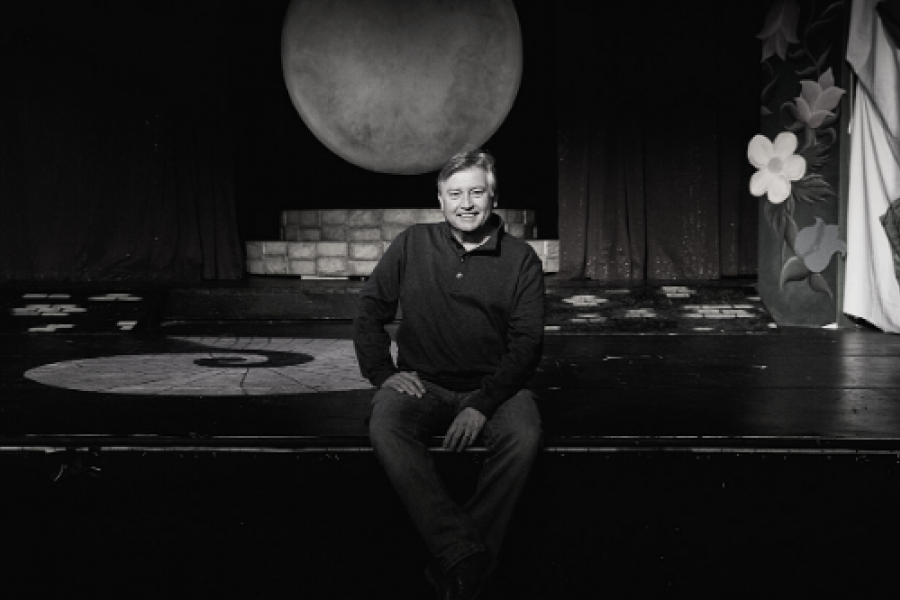 jim barber sitting on stage