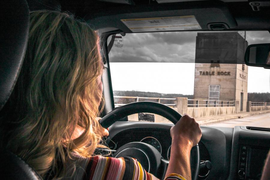 woman driving across table rock dam