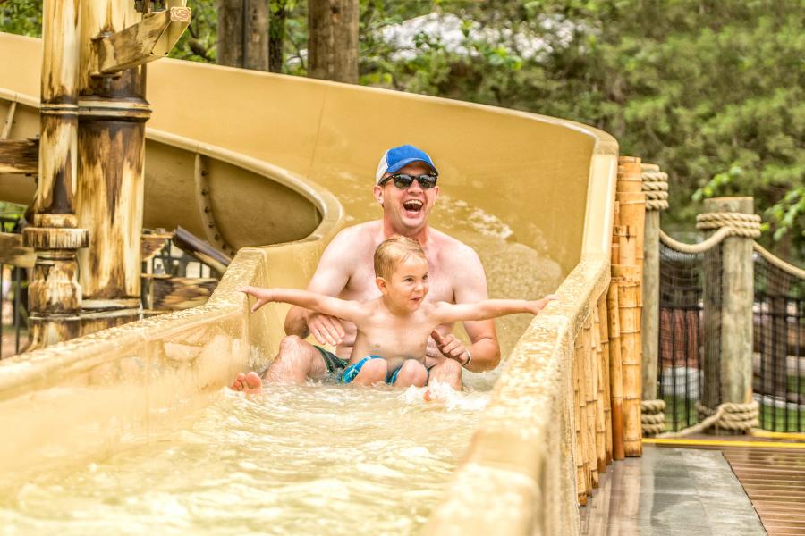 dad and son slide down water slide in branson mo