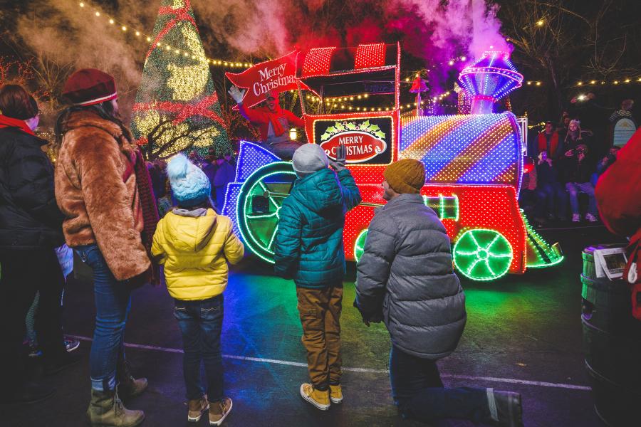 family standing in front of christmas parade at silver dollar city in branson