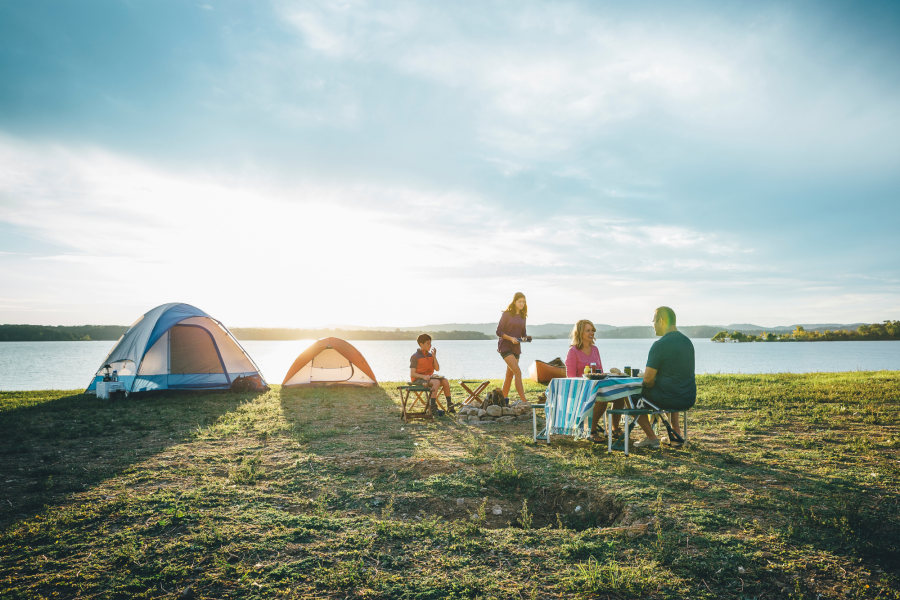 family camping on lakeshore