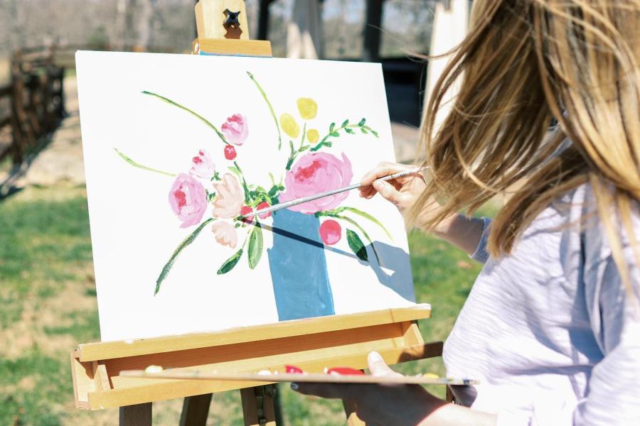 woman painting flowers near branson mo