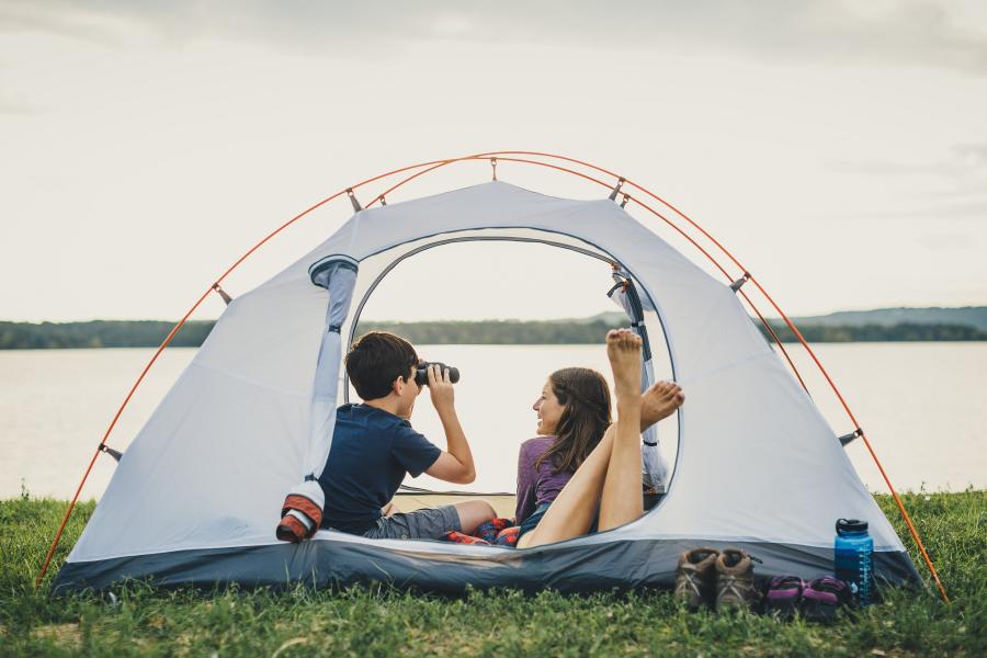Two kids in a tent in front of table rock lake