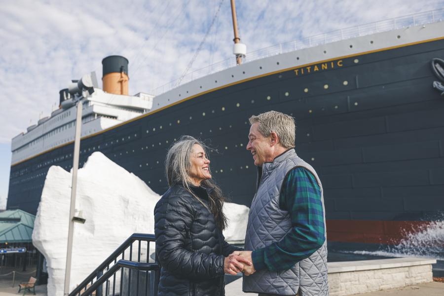 A couple standing in front of the titanic