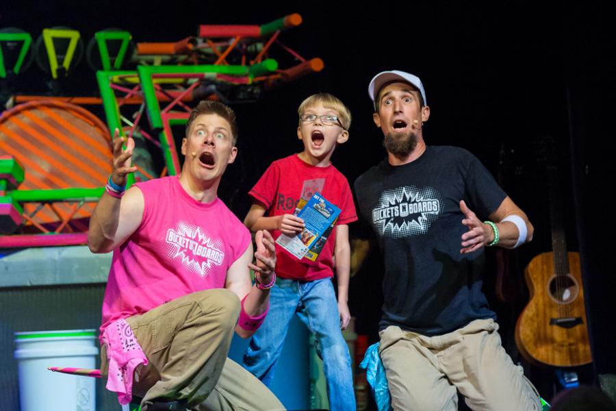 Two men and a young boy shocked by what they see in the audience at a live show in Branson.
