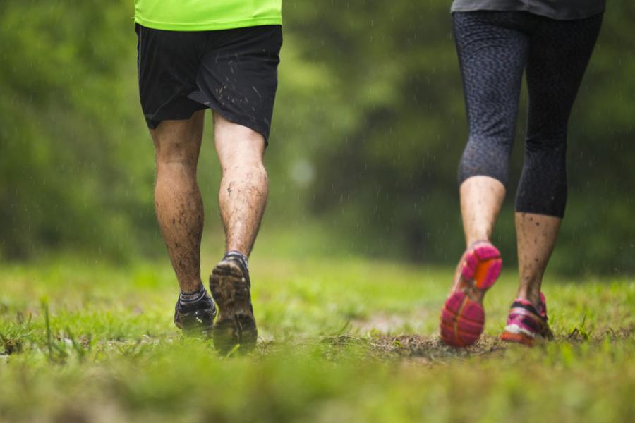 Man and woman jogging on a dirt trail in Branson. 