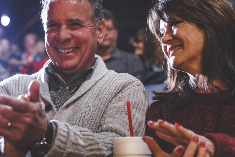 Middle-aged couple sitting in a theatre about to watch a show in Branson.