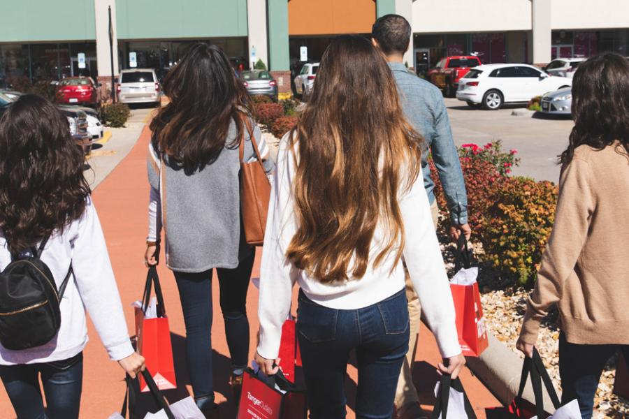 Family of five shopping at an outlet mall.