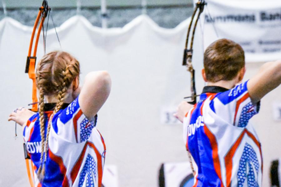 Two contenders shooting in a State Archery Tournament.