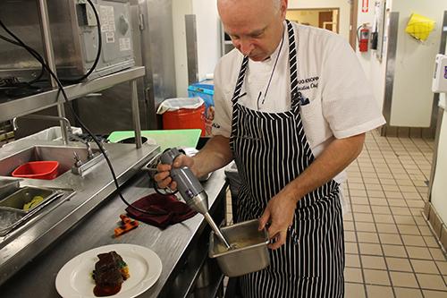 chef cooking in kitchen at chateau on the lake