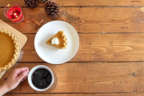 pumpkin pie and coffee flat lay on wooden table