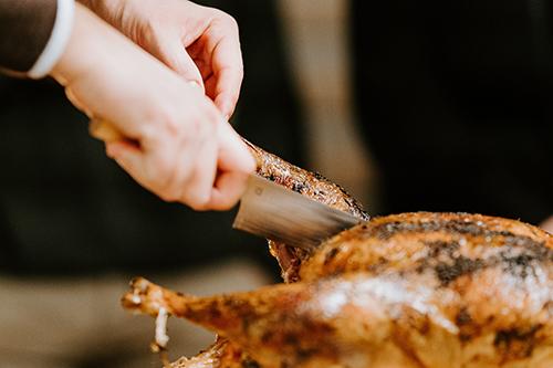 hands up close carving a turkey