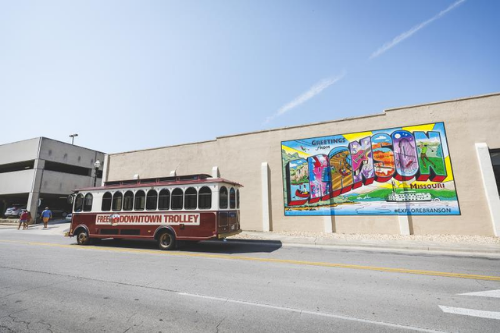 Downtown Trolley in front of the explorebranson postcard mural