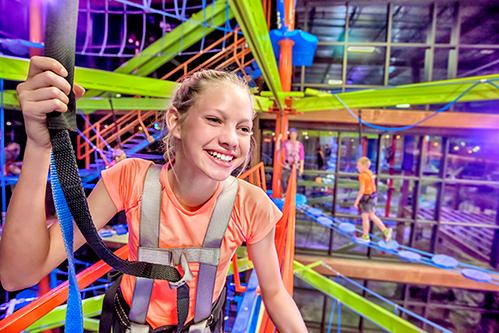 Girl climbing the ropes course at Fritz's Adventure.