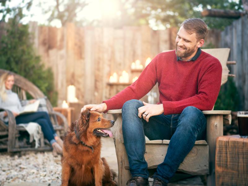 A man camping with his dog.