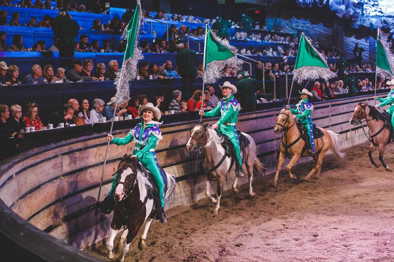 Trick riders waving flags at Dolly Parton's Stampede.