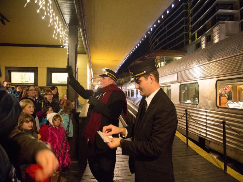 Train conductor handing out tickets at the Polar Express