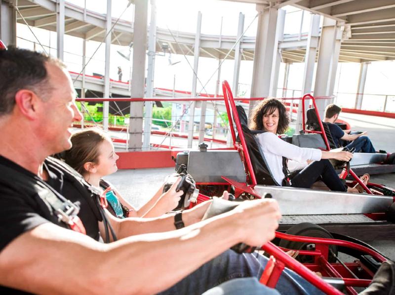a family enjoying riding go karts on a nice day