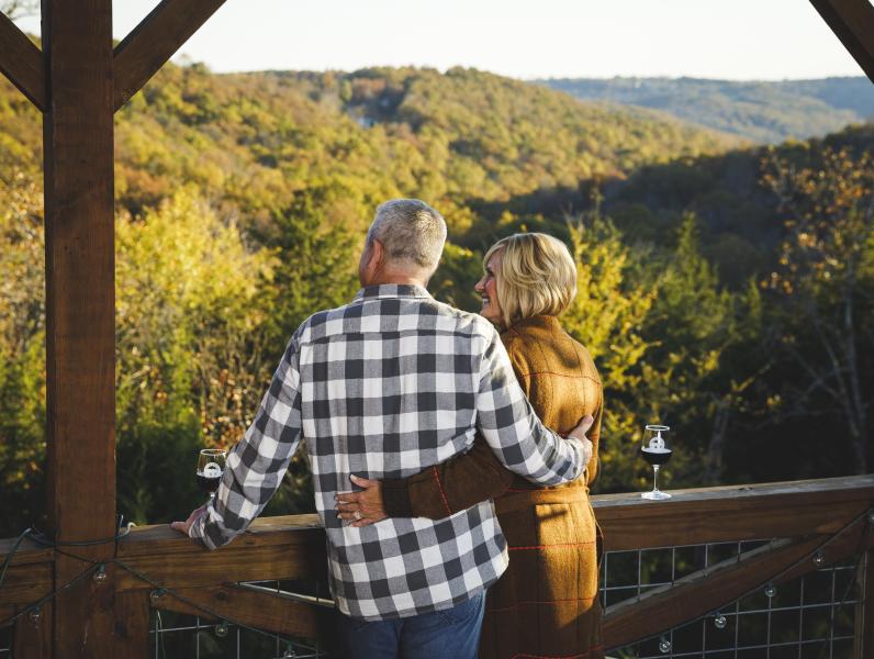 Couple drinking wine overlooking fall scenery