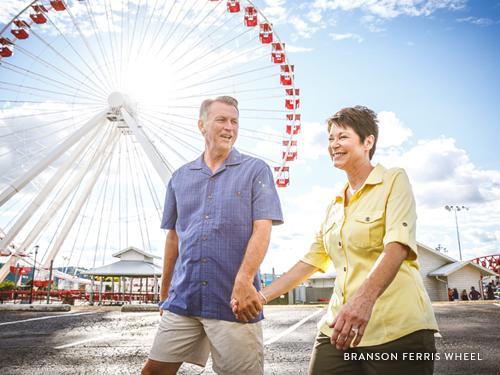 A couple walking to the Branson Ferris Wheel.