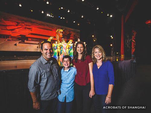 Family of four watching an acrobatic show in Branson.