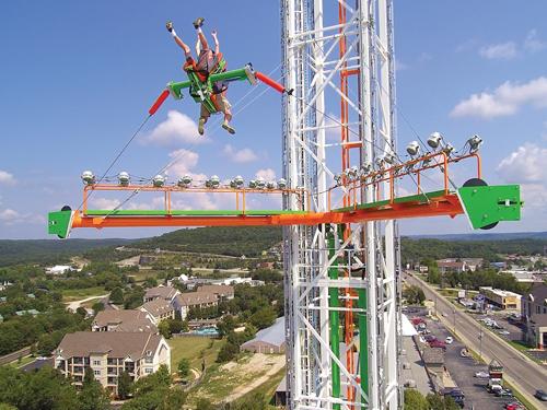 Thrill seekers riding a 200' tall slingshot attraction in Branson.