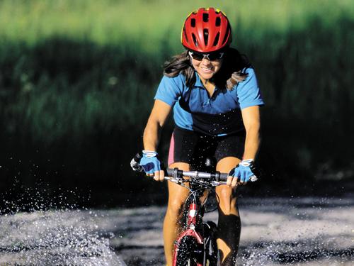 Woman riding bike on trail in Branson.