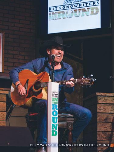 Man wearing black cowboy hat singing classic country songs on a live show stage in Branson.
