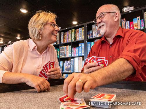 Middle-aged couple on a date and playing cards in Branson.